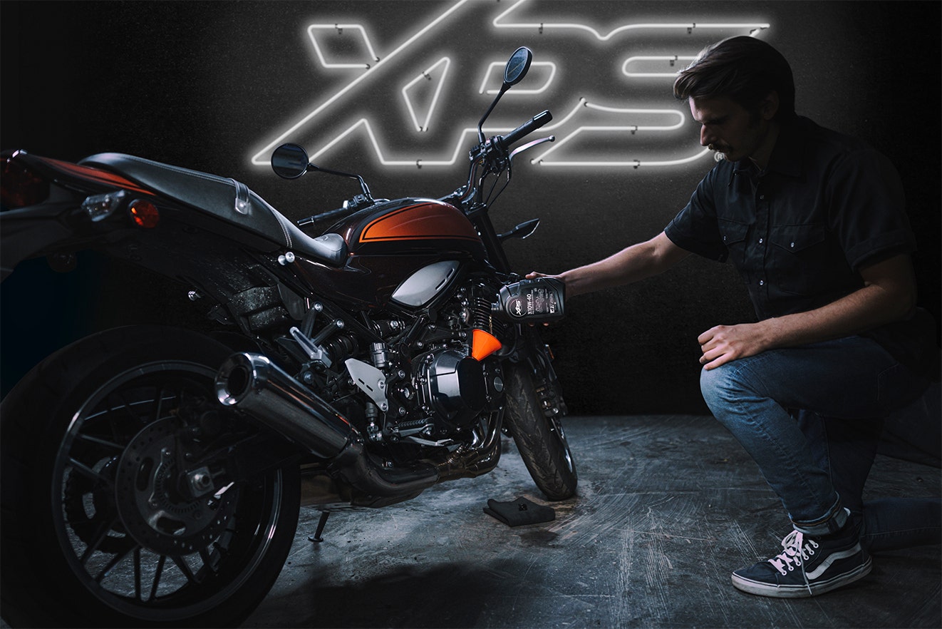 Man maintaining his motorbike with XPS oil